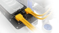 High‑voltage connectors with bright yellow cables attached to an electric vehicle’s battery system. High‑voltage connectors with bright yellow cables attached to an electric vehicle’s battery system.