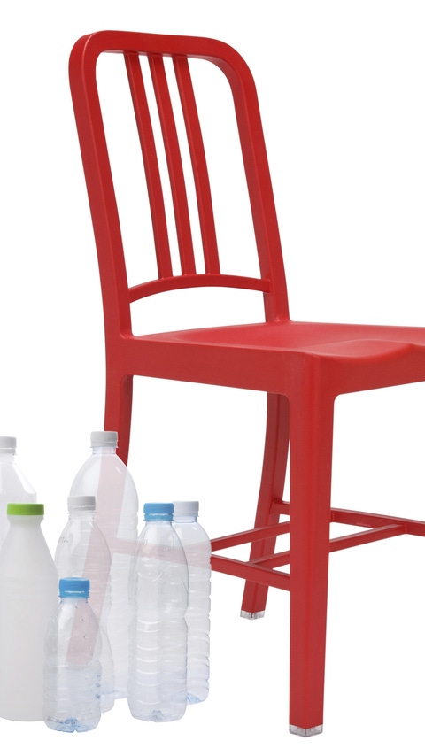 Empty water bottles beside a red chair Empty water bottles beside a red chair